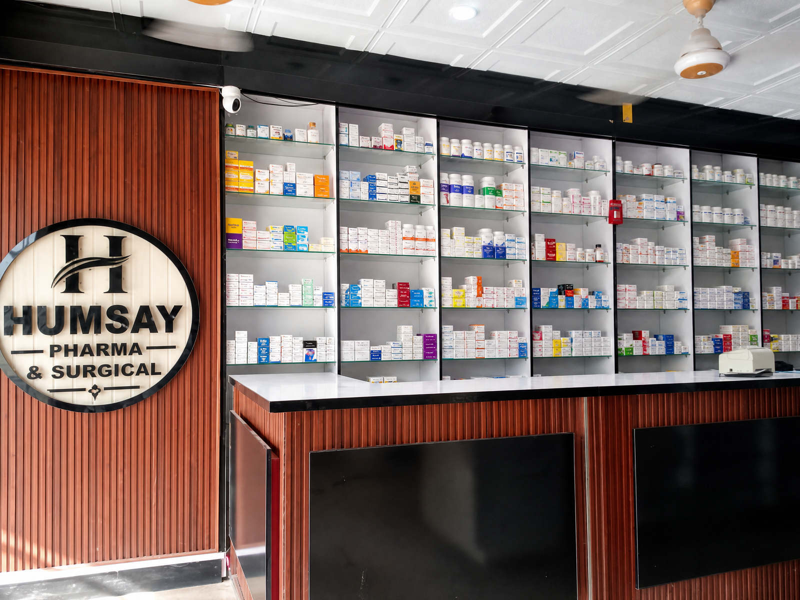 Humsay Pharmacy counter and logo